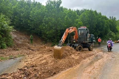Competent forces clear a landslide site on National Highway 14G in Hoa Vang commune, Da Nang city. (Photo: VNA) 
