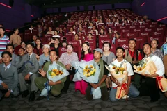The film's cast and crew and the audience at the screening (Photo: VNA)