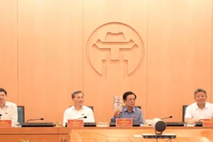 The National Assembly supervisory delegation at the working session with Hanoi authorities (Photo: VNA)