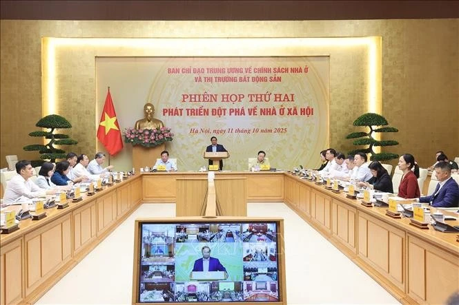 Prime Minister Pham Minh Chinh (standing) speaks at the second meeting of the Central Steering Committee for Housing Policy and Real Estate Market on October 11 in Ha Noi. (Photo: VNA)
