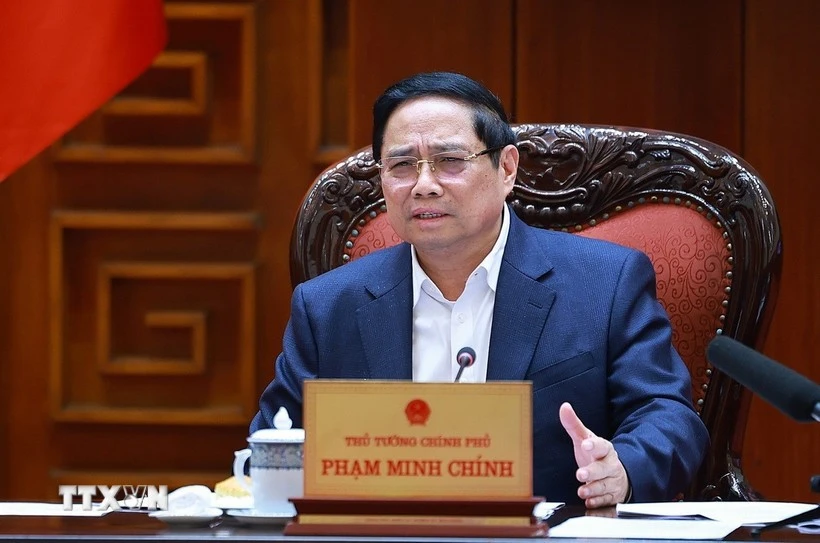 Prime Minister Pham Minh Chinh speaks at the meeting between the Government’s standing members and ministries, sectors and localities on December 16 on preparations for the ground-breaking and inauguration ceremonies for projects celebrating the 14th National Party Congress (Photo: VNA)