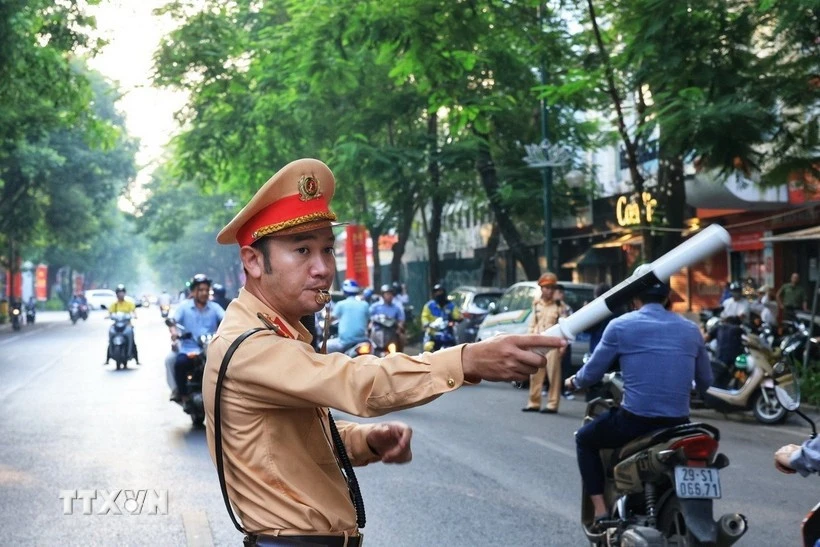 A traffic police officer regulates the traffic flow on a street in Ha Noi. (Illustrative photo: VNA)