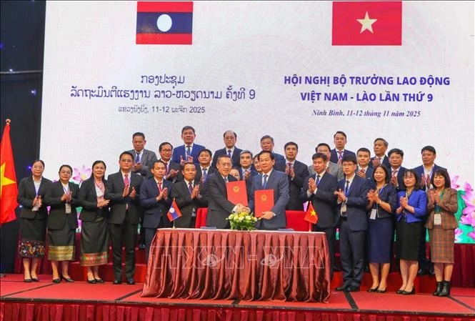 The signing ceremony of the MoU on cooperation in the areas of labour and revolution contributors between the Vietnamese Ministry of Home Affairs and Lao Ministry of Labour and Social Welfare. (Photo: VNA)