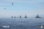 Formations of DHC-6 aircraft and Ka-28 anti-submarine helicopters, together with missile ship squadrons, take part in a naval parade in the waters of Cam Ranh, Khanh Hoa province, during the ceremony and parade celebrating the 80th anniversary of the August Revolution and National Day (September 2). (Photo: VNA)