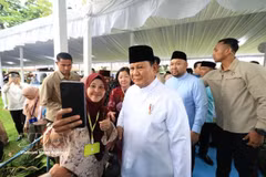 Indonesian President Prabowo Subianto poses for a photo with a visitor to the Presidential Palace of Indonesia in Jakarta. (Photo: VNA)