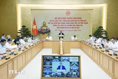 Prime Minister Pham Minh Chinh chairs a national teleconference to review the fight against smuggling, trade fraud, counterfeit goods, and intellectual property rights infringement. (Photo: VNA)