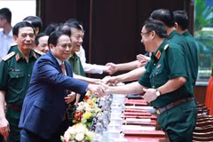 Prime Minister Pham Minh Chinh (front, left) attends the national military-political conference on July 2. (Photo: VNA)