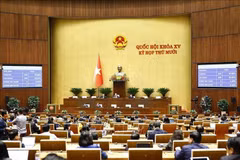 The National Assembly votes to pass the revised Law on Judicial Expertise. (Photo: VNA)