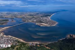 Spanning the estuary near Thien Cam Beach, Cua Nhuong Bridge features an arched design that creates an impressive vista. (Photo: VNA)
