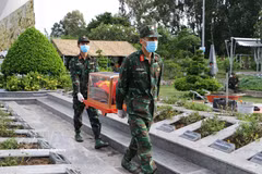 A specialised team collects samples from the remains of martyrs at the provincial martyrs' cemetery (My Tra ward). (Photo: VNA)