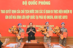 Senior Lieutenant General Phung Si Tan (second from left), Deputy Chief of the General Staff, presents decisions of the State President and the Minister of National Defence to three officers who are about to depart for duties at the UN peacekeeping mission in Abyei. (Photo: VNA)