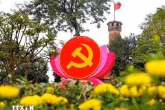 Flags, flowers, and banners adorn a street in Hanoi to welcome the 14th National Party Congress. (Photo: VNA)