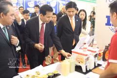Delegates visit a booth of Vietnamese food processing businesses at the event (Photo: VNA)
