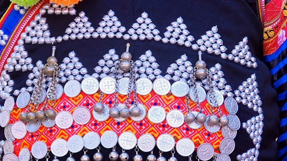 Embroidered patterns and silver jewelry decorate the costume of a Ha Nhi ethnic woman. (Photo: VNA)