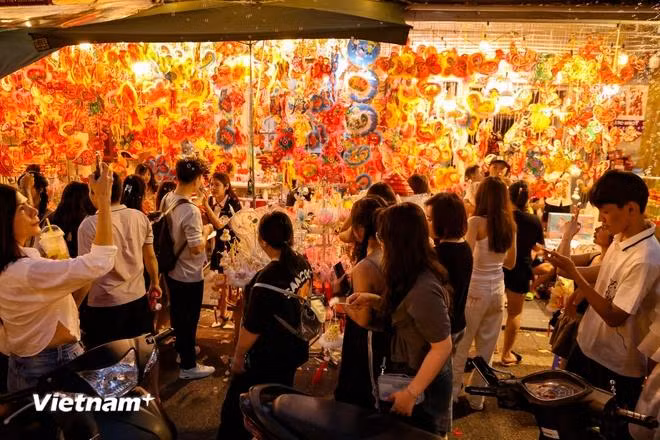 The street is bathed in red by eye-catching toys and decorations. (Photo: VietnamPlus)