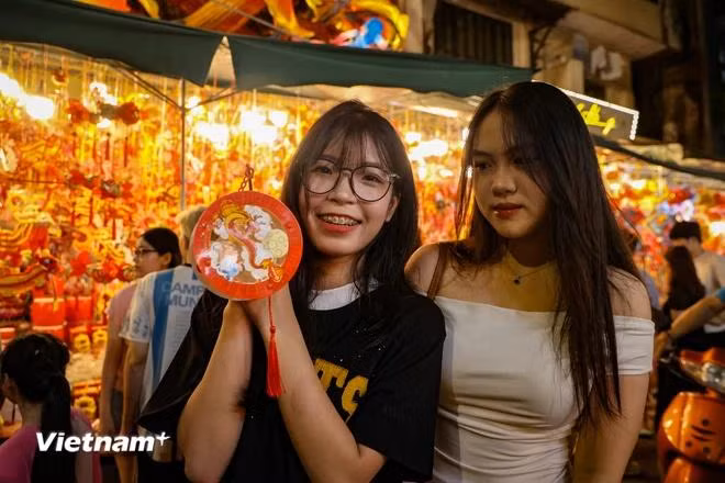 Nguyen Ngoc Anh from Nam Dinh said that due to the rainy and stormy weather, she hadn’t had the chance to go out and enjoy the pre-Mid-Autumn Festival atmosphere for the past two weeks. "As today is the Mid-Autumn Festival, I and my friends decide to go out and enjoy the festive atmosphere," Ngc Anh said. (Photo: Minh VietnamPlus)