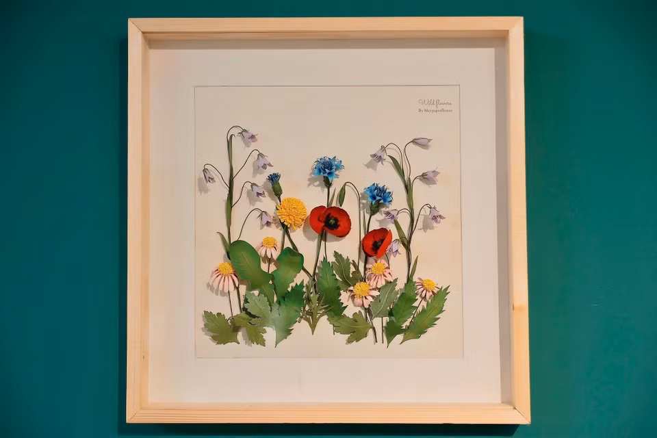 The picture frames are made from high-quality wood with a glass cover to keep out dust and dirt. (Photo: VNA)