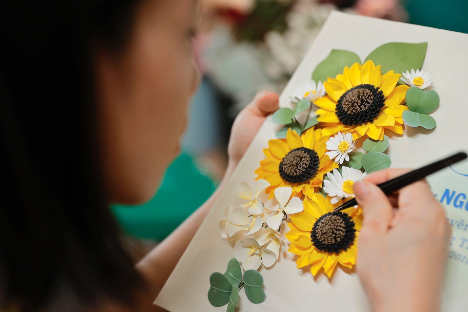 Behind every new product line is the creativity and dedication of many people. (Photo: VNA)