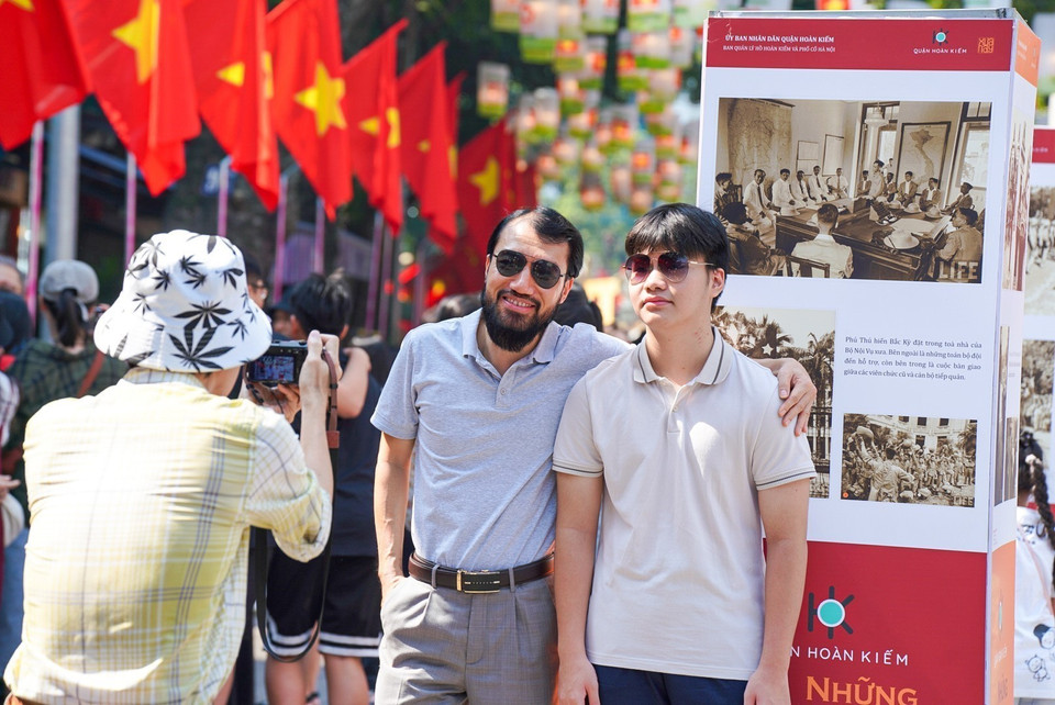Tourists pose for photos on Phung Hung street. (Photo: VNA)