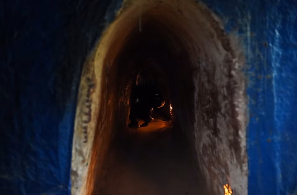 Visitors must crouch low to navigate the dark, narrow spaces within the tunnels. (Photo: VNA)
