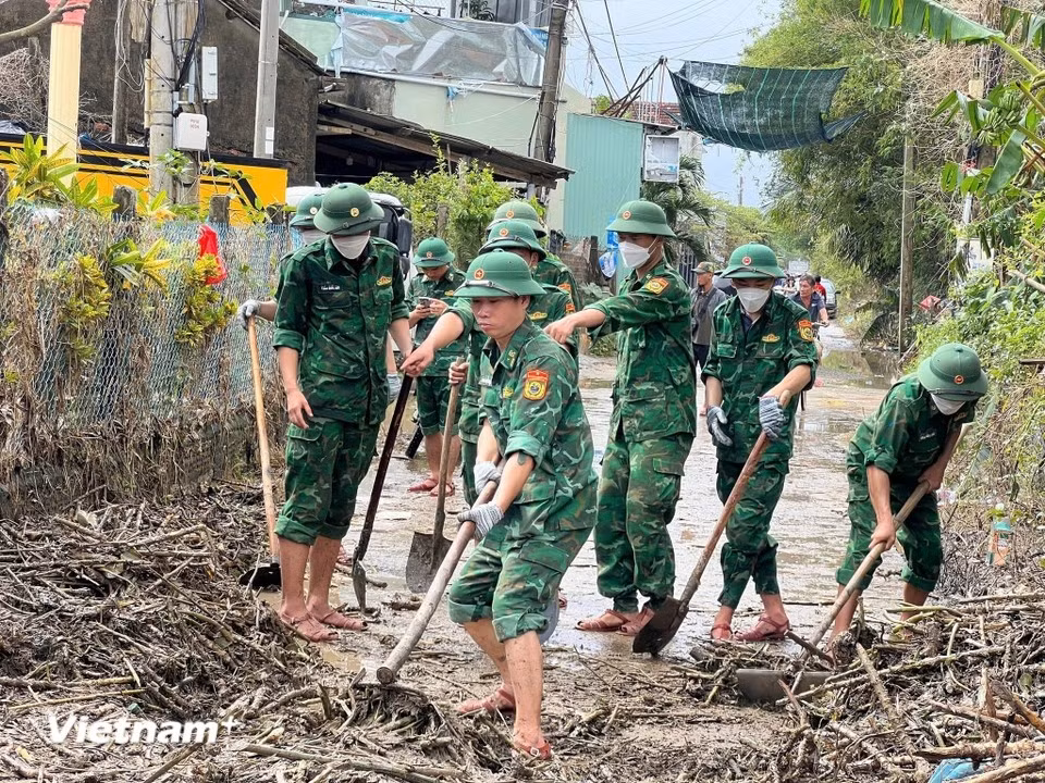 Border Guard soldiers in Dak Lak province clean roads and homes after the floods. (Photo: Vietnam+)