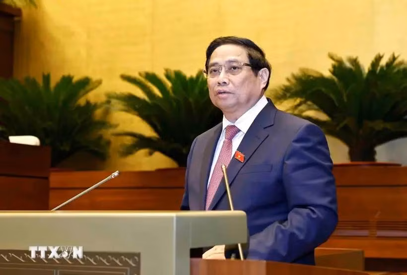 Prime Minister Pham Minh Chinh delivers a report at the ongoing 8th session of the 15th National Assembly in Hanoi on October 21. (Photo: VNA)