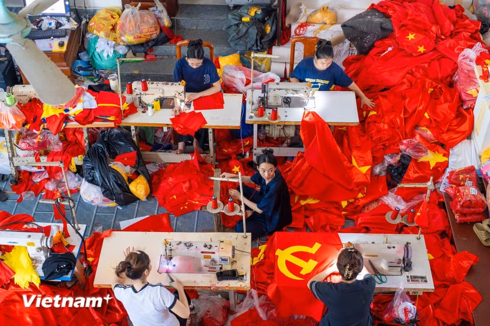 In workshops and households, machines run non-stop, with flags meticulously crafted by hand. (Photo: Vietnam+)