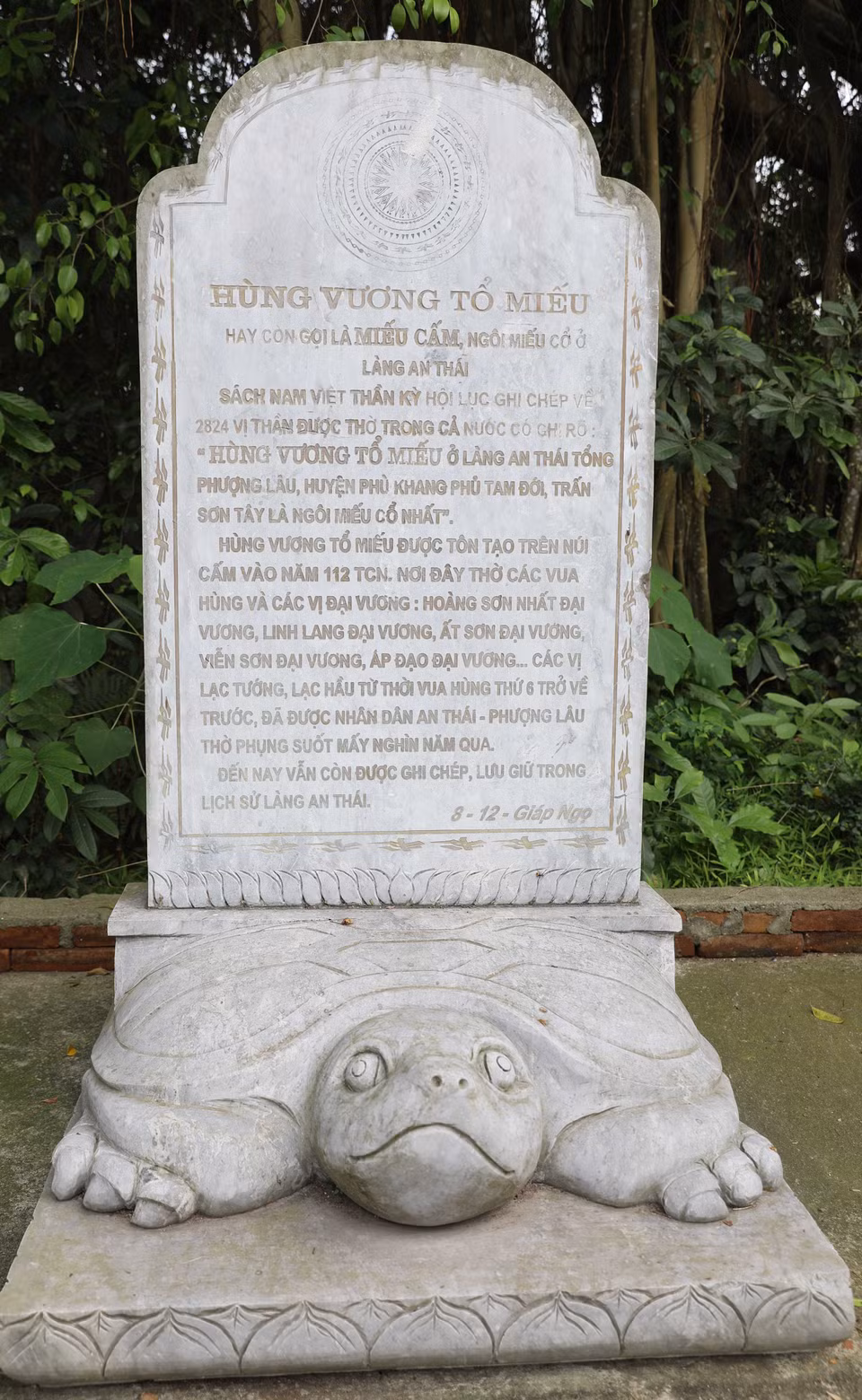 Stele inscribed with the name of the Hung Kings Ancestral Temple stands beside the shrine. (Photo: VNA)