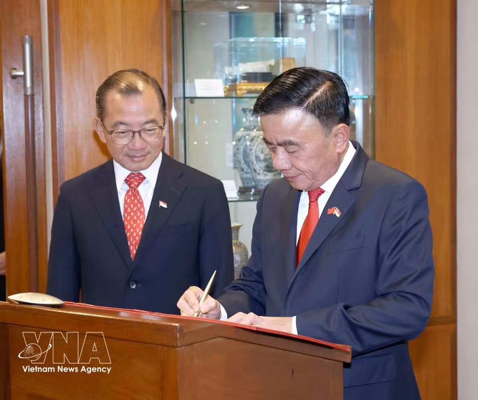 Member of the Political Bureau and Permanent Member of the Secretariat of the CPV Central Committee Tran Cam Tu writes in the visitors’ book at Singapore’s Parliament House. (Photo: Phuong Hoa/VNA)