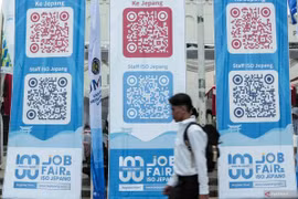 A jobseeker passing by banners imbued with QR codes of overseas job vacancies during a job fair in Sukabumi City, West Java, on August 29, 2024. (Photo: ANTARA FOTO/Henry Purba/agr/rwa)