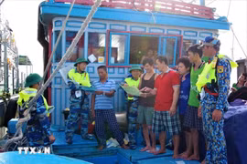 Ba Ria-Vung Tau Border Guards distribute leaflets to disseminate legal regulations for fishermen while operating at sea. (Photo: VNA)