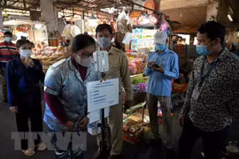 COVID-19 continues spreading in Cambodia, reducing in Laos