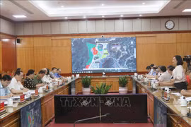 At the working session (Photo: VNA)