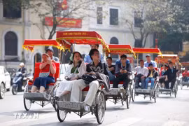 Tourists take a street tour on pedicabs in Hanoi. (Photo: VNA)