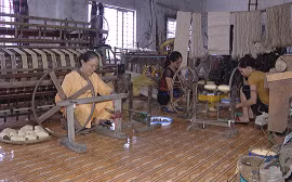 Woman weaves silk from lotus