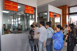 People wait for their procedures processed at a border gate between Laos and Vietnam (Photo: VNA)