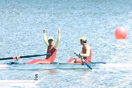 Dam Van Hieu and Nguyen Dinh Huy celebrate their victory in the men's pairs 500m rowing event.