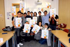 UCL students pose for a photo to promote the day (Photo: VNA)