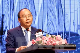 PM urges Hanoi to remove barriers for stronger development