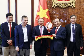 President receives football head coaches
