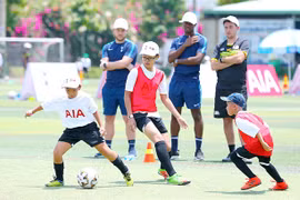 English football coaches train kids in Vietnam