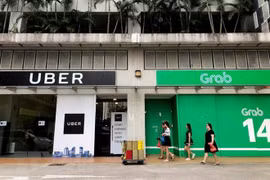 Singapore sets interim measures for Grab-Uber merger