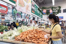 Customers shop at a supermarket in HCM City. (Photo: VNA)