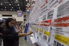 A visitor browses travel promotions at a travel fair in Nonthaburi province. (Photo: Bangkok Post)