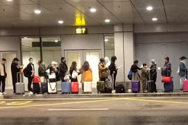 Passengers have samples taken for COVID-19 testing right at airports