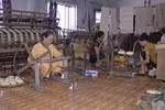 Woman weaves silk from lotus