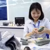 The daily reference exchange rate is set at 25,600 VND/USD on August 21. (Photo: VNA)
